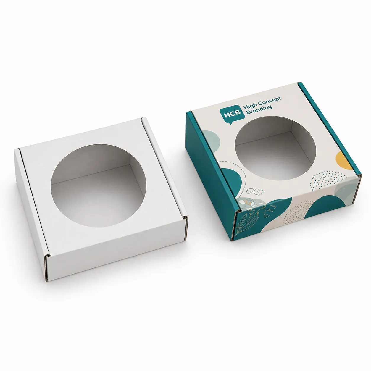 Square white and branded boxes featuring a circular die-cut window for enhanced product visibility on retail shelves. class=